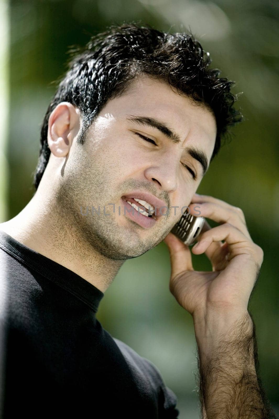 Close-up of a young man talking on a mobile phone
