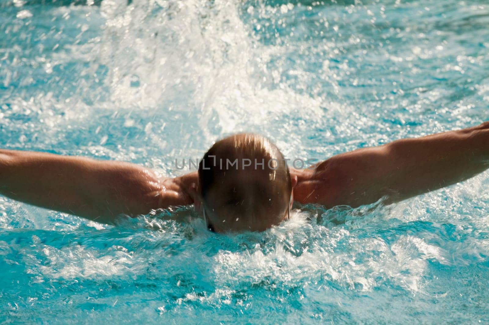Mid adult man swimming in a swimming pool
