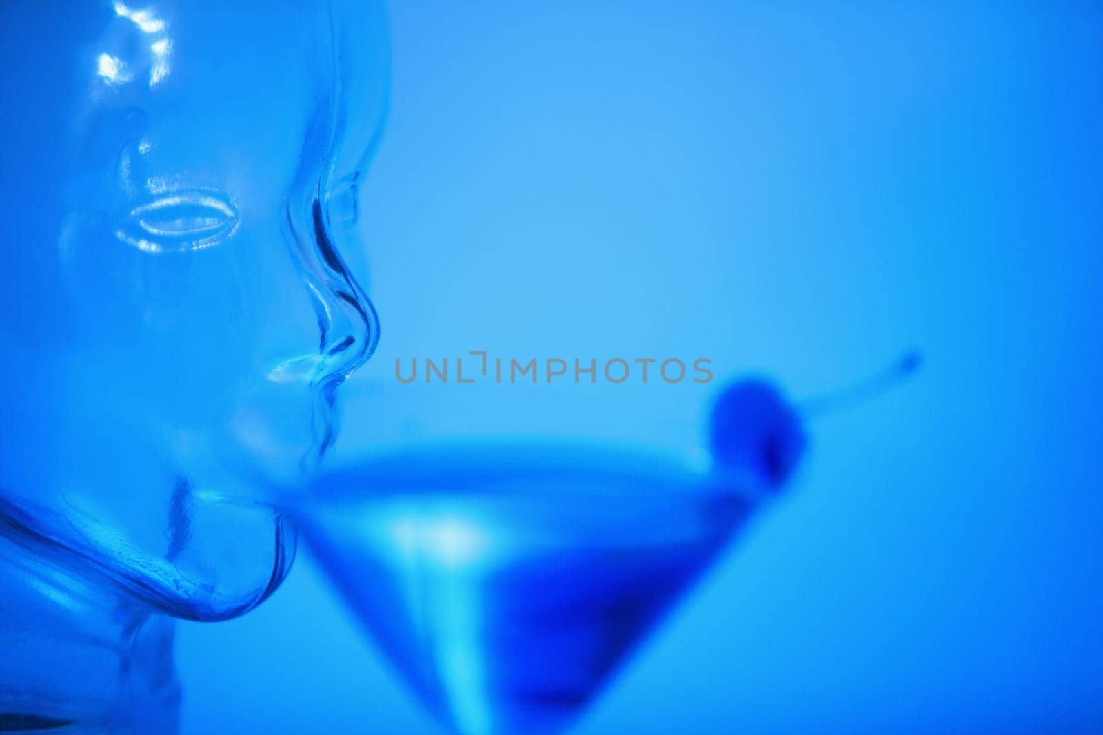 Close-up of a glass mannequin drinking a glass of martini