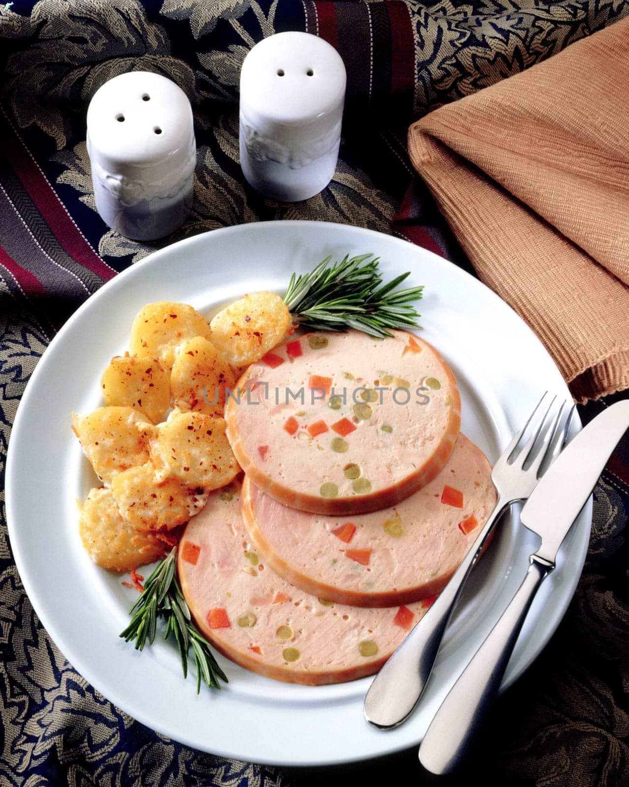 Slice of salami with potato in a plate