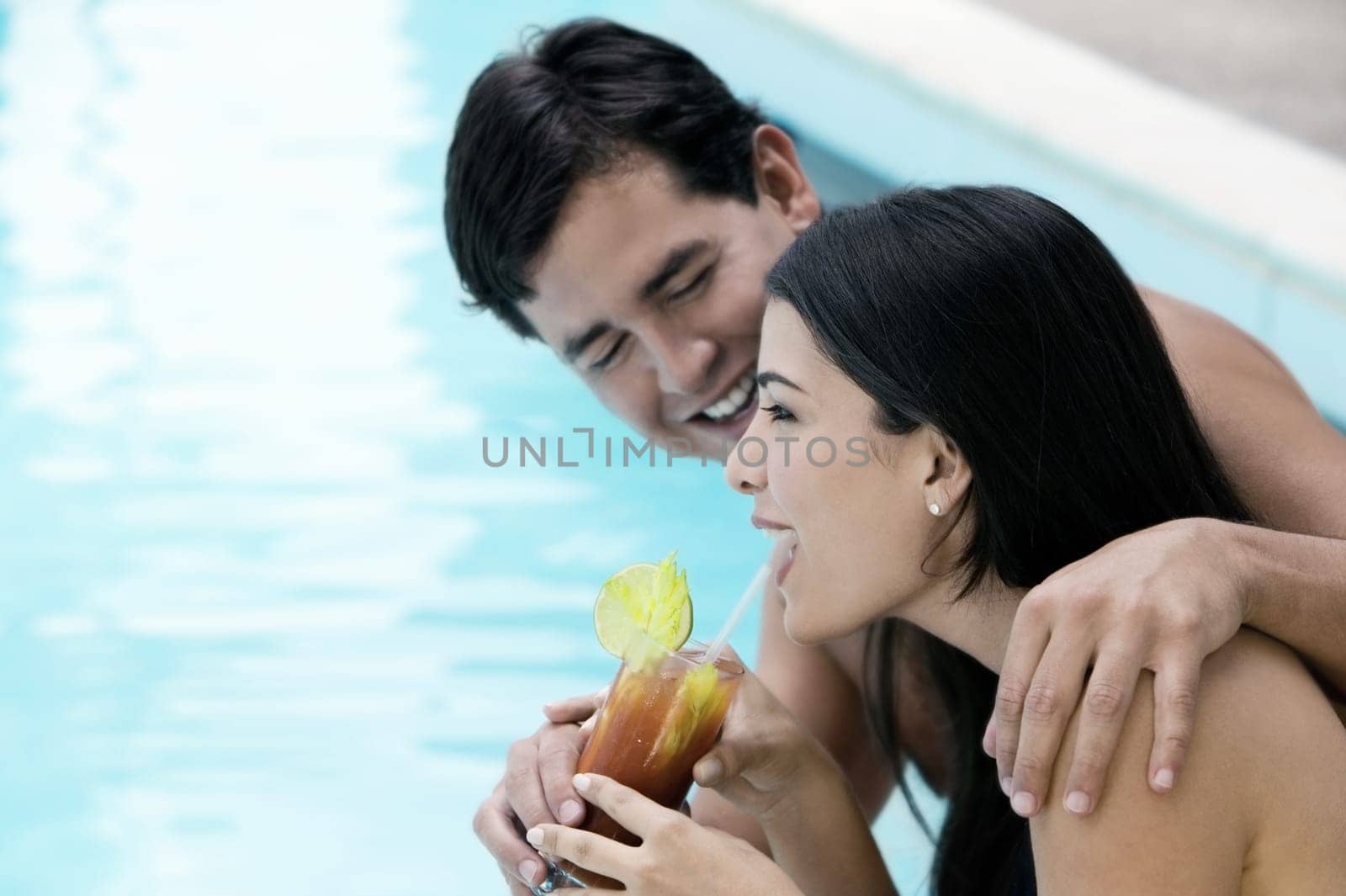 Side profile of a young couple holding a glass of drink