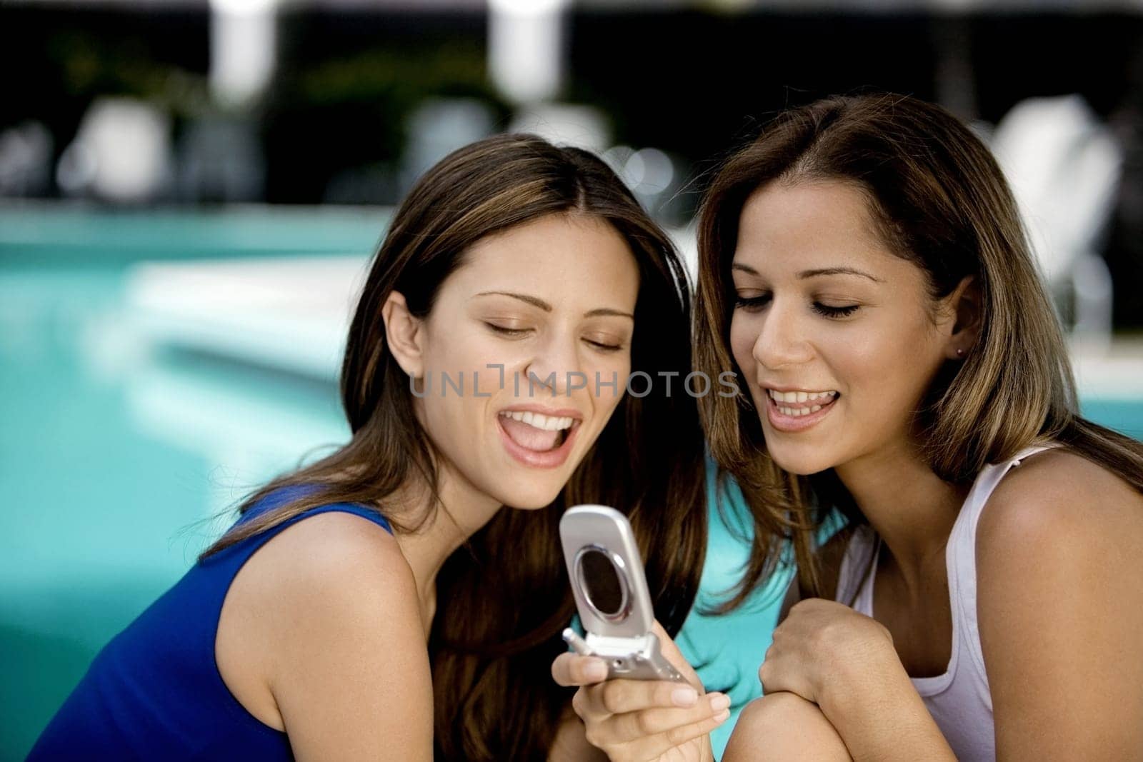 Close-up of two young women holding a mobile phone