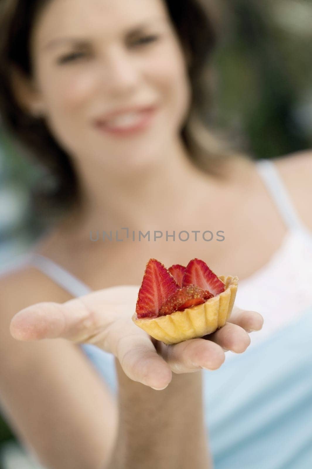 Close-up of a cupcake on a young womanŽs hand