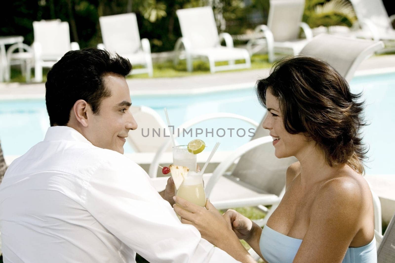 Side profile of a young couple holding drinks