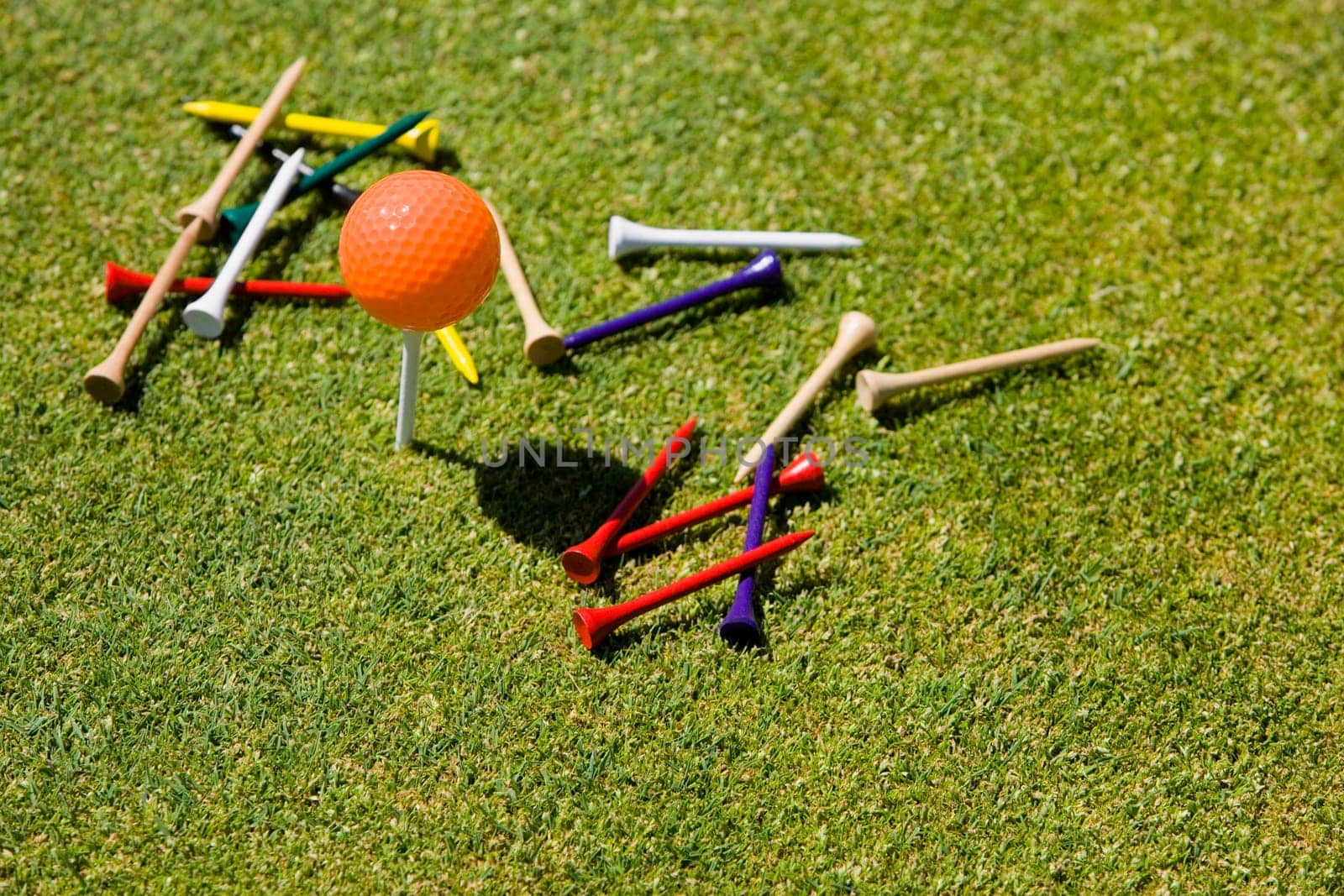 High angle view of a golf ball and tees