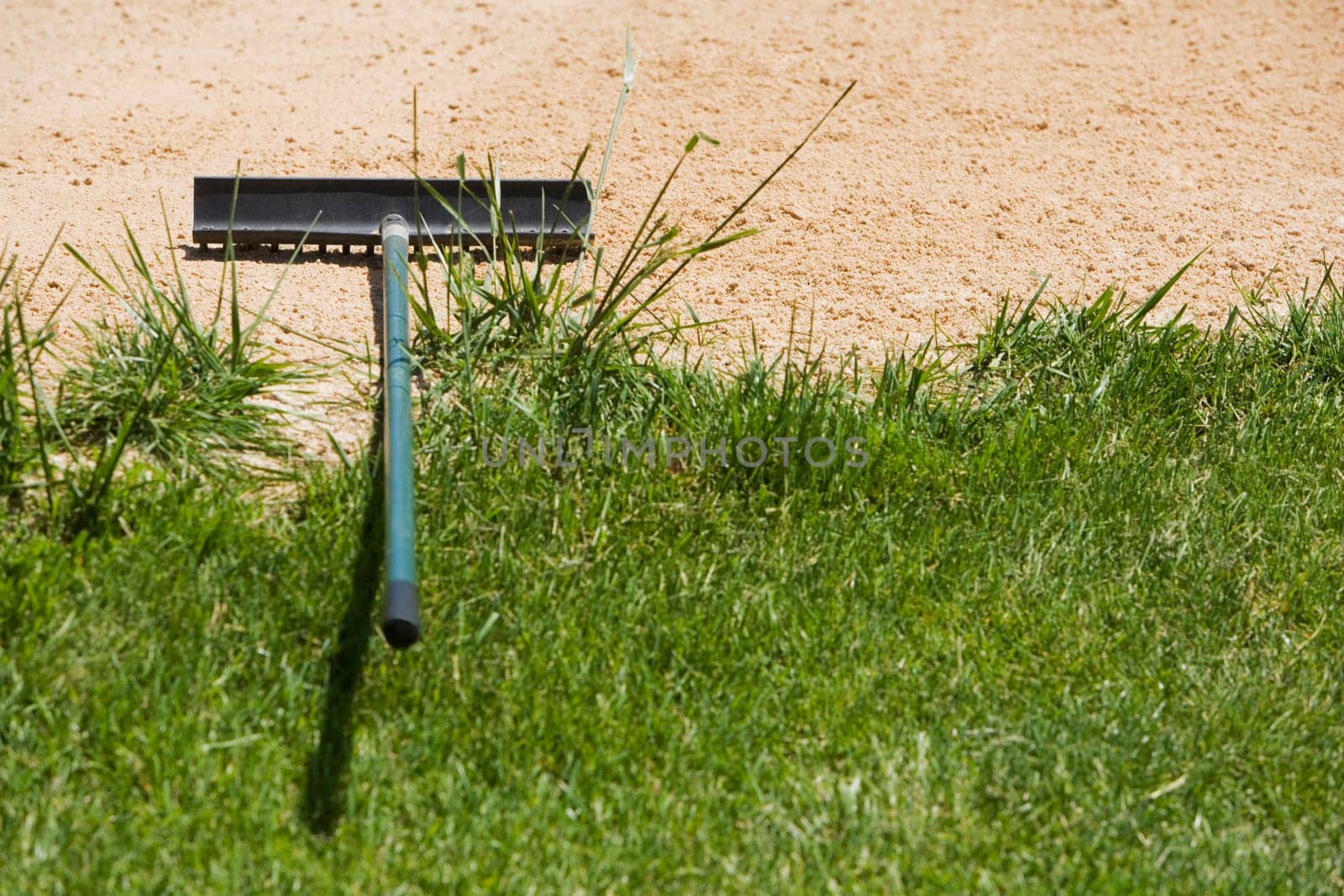 High angle view of a rake on sand