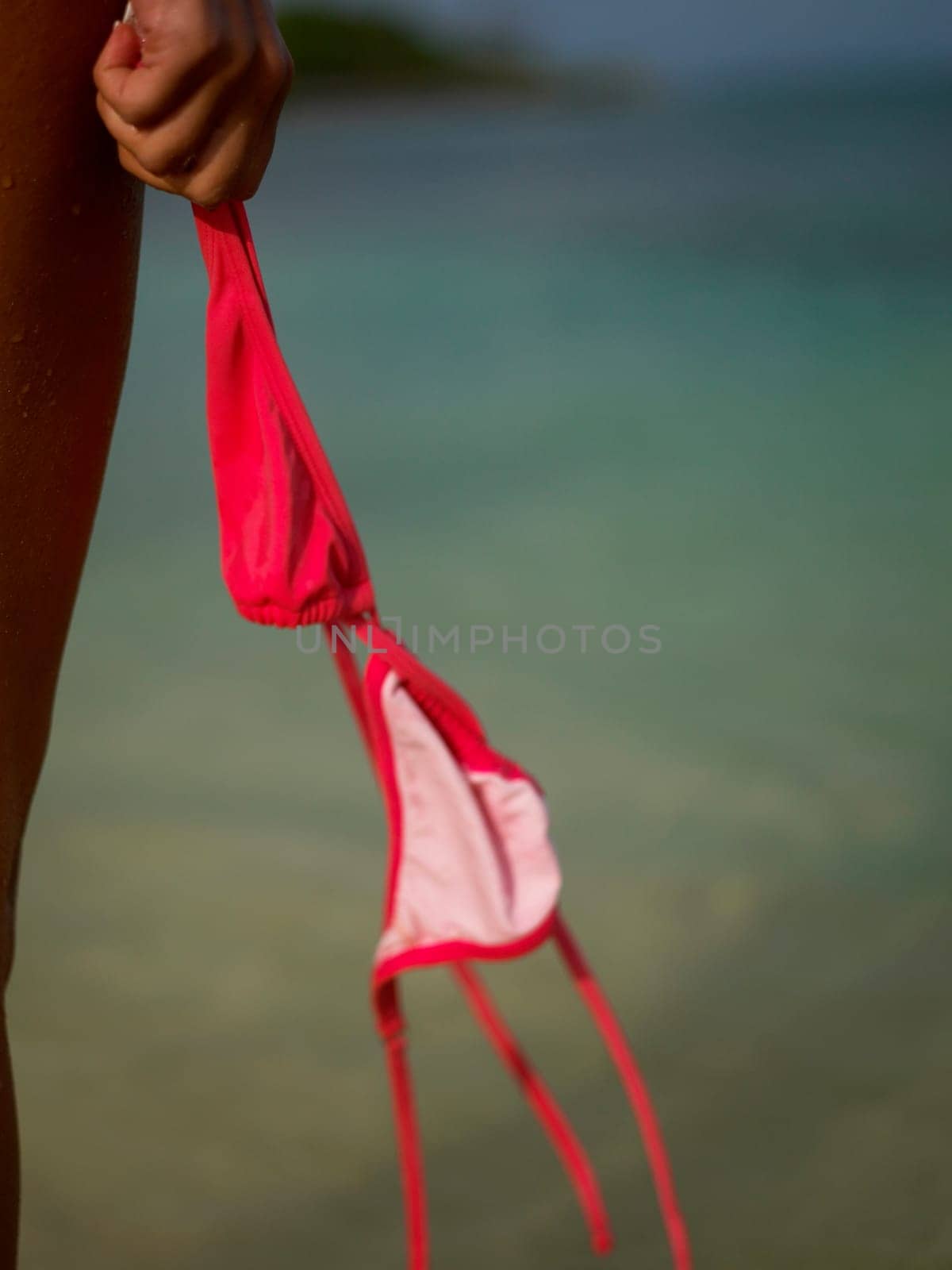 Close-up of a womanŽs hand holding a bikini top