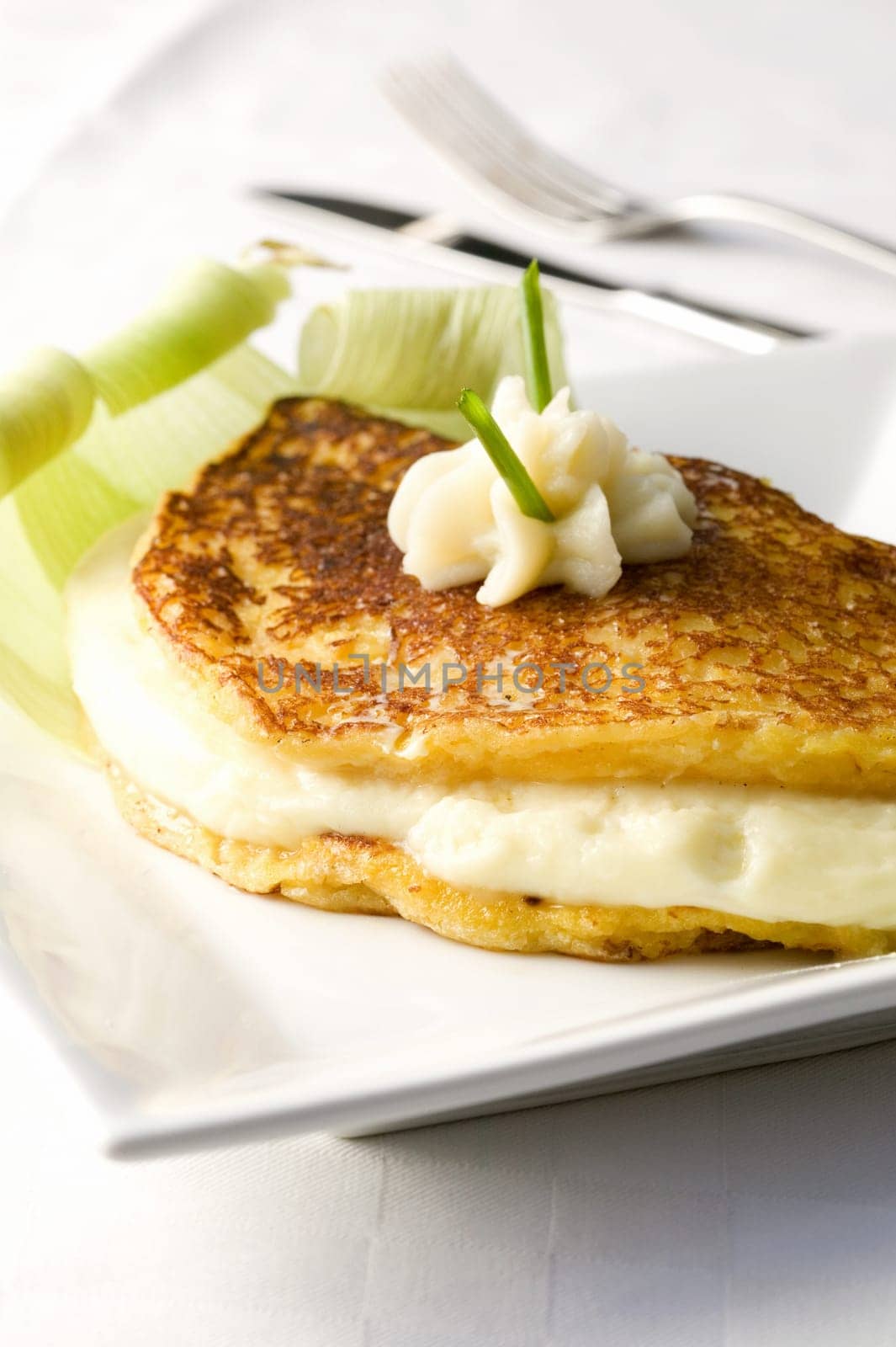 Close-up of a fish fillet with whipped cream on it