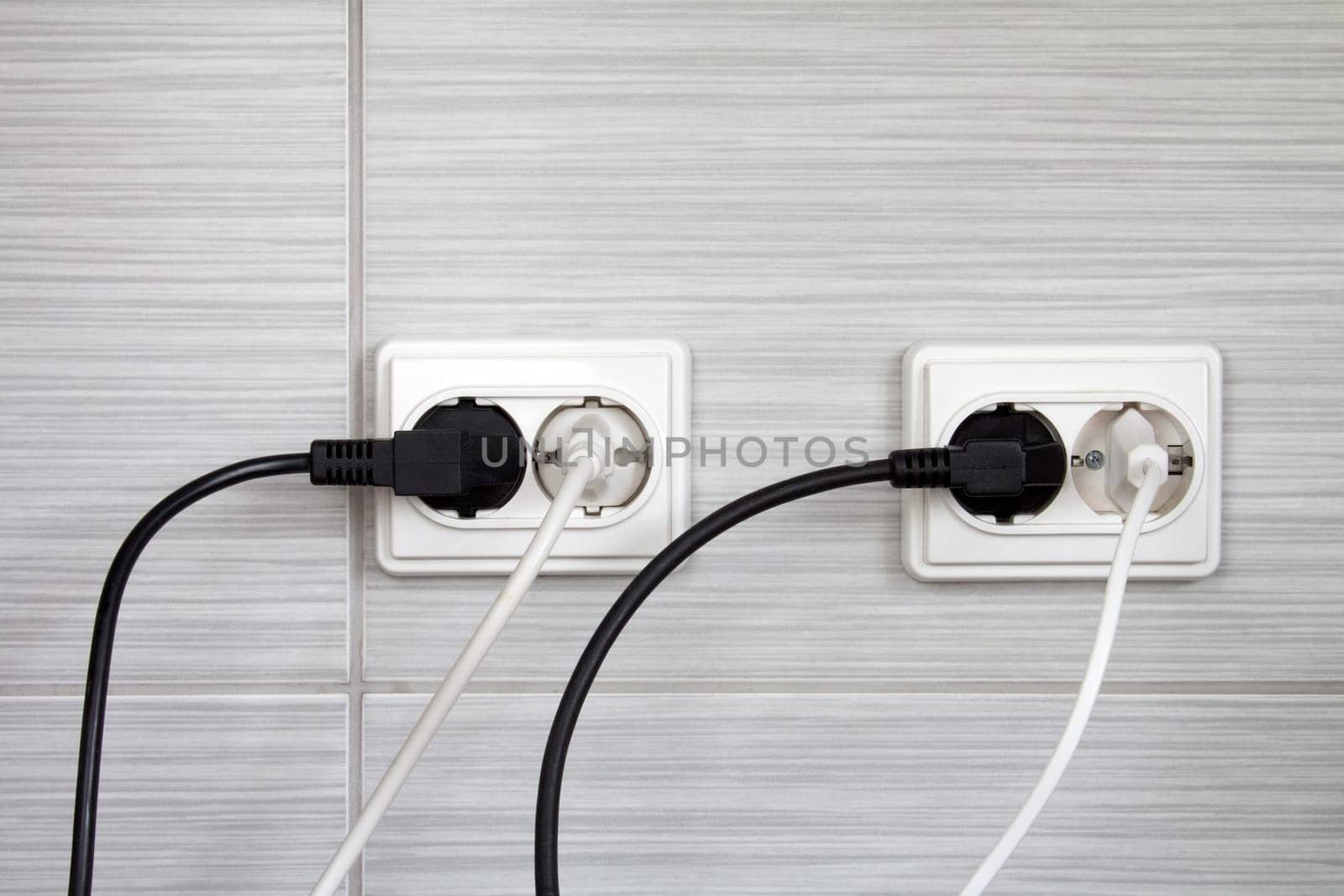 Electrical plugs connected into the wall sockets