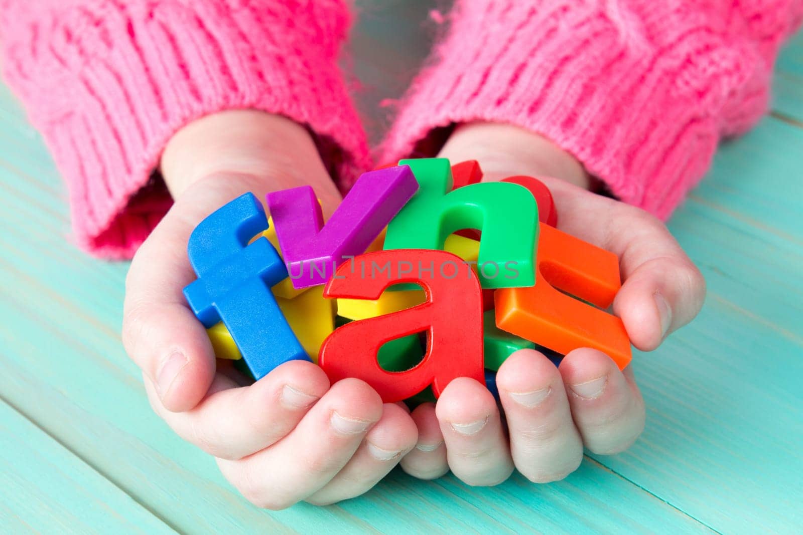 Child learning to read using magnetic letters. Education School  Concept