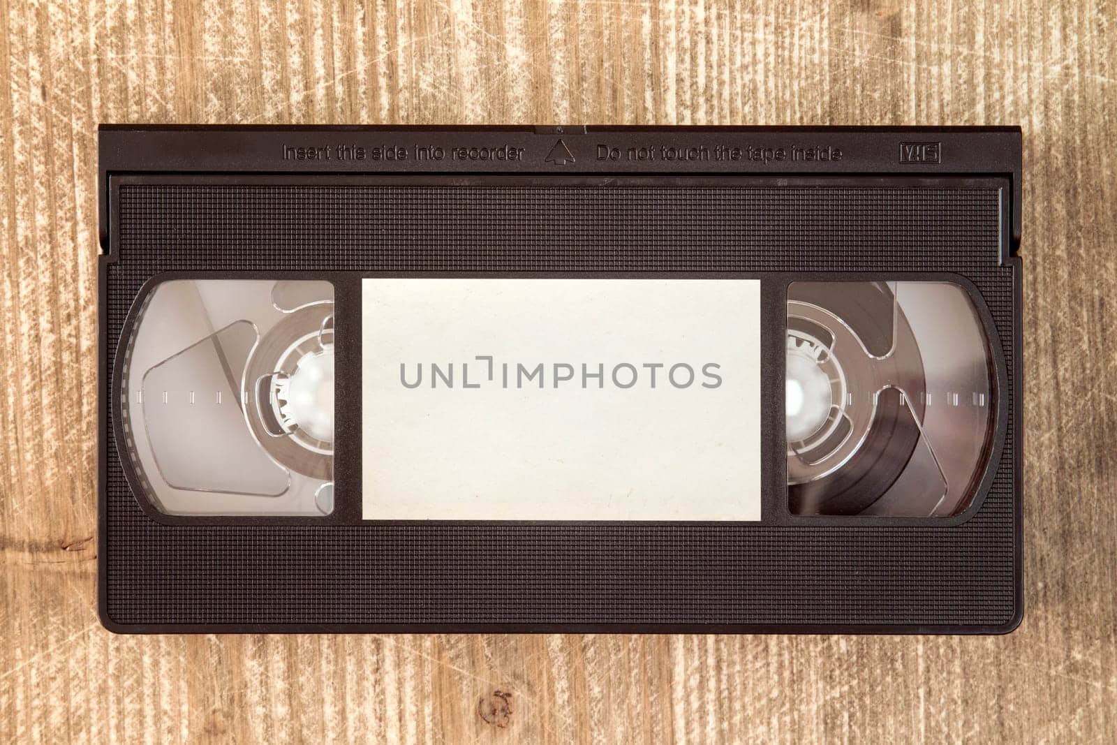 VHS video tape cassette on wooden background.Copy-space.
