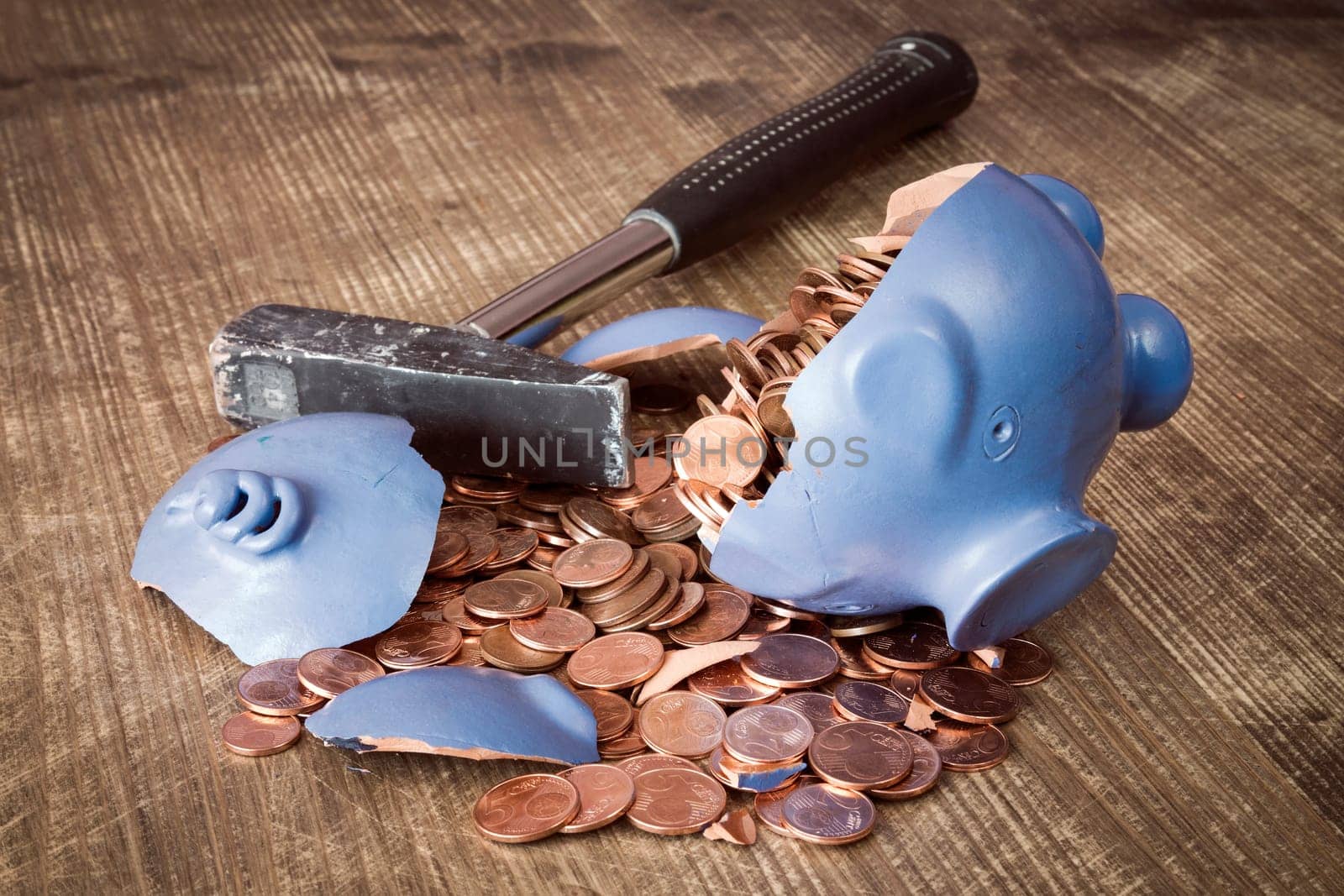 Broken piggy bank with hammer and money