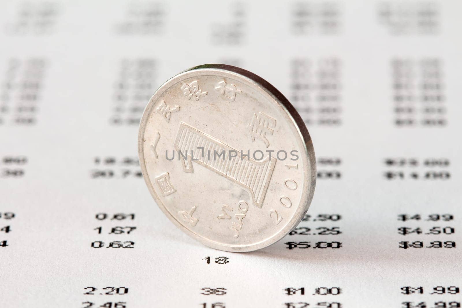 Chinese One Yuan coin and financial report. Rate of the Chinese Yuan