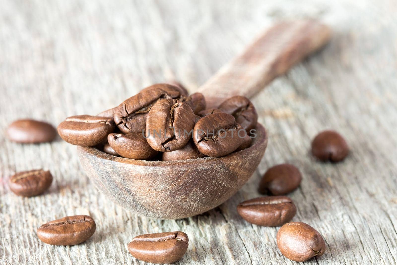 Close up view of spoon with coffee crop beans