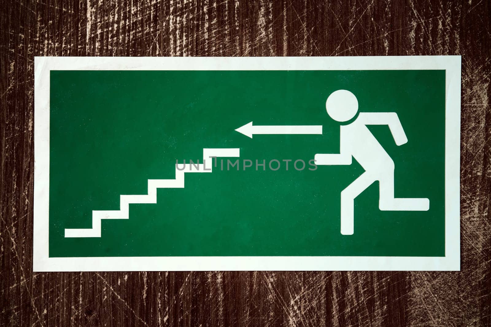 Green emergency fire exit with arrow direction to left side