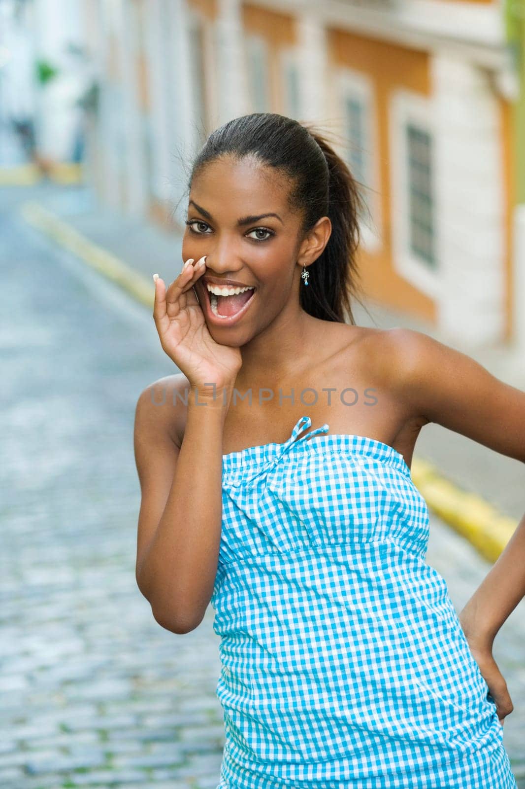 Portrait of a teenage girl smiling with her hand on her hip