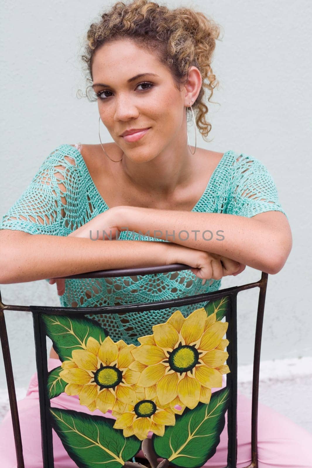 Portrait of a teenage girl sitting on a chair
