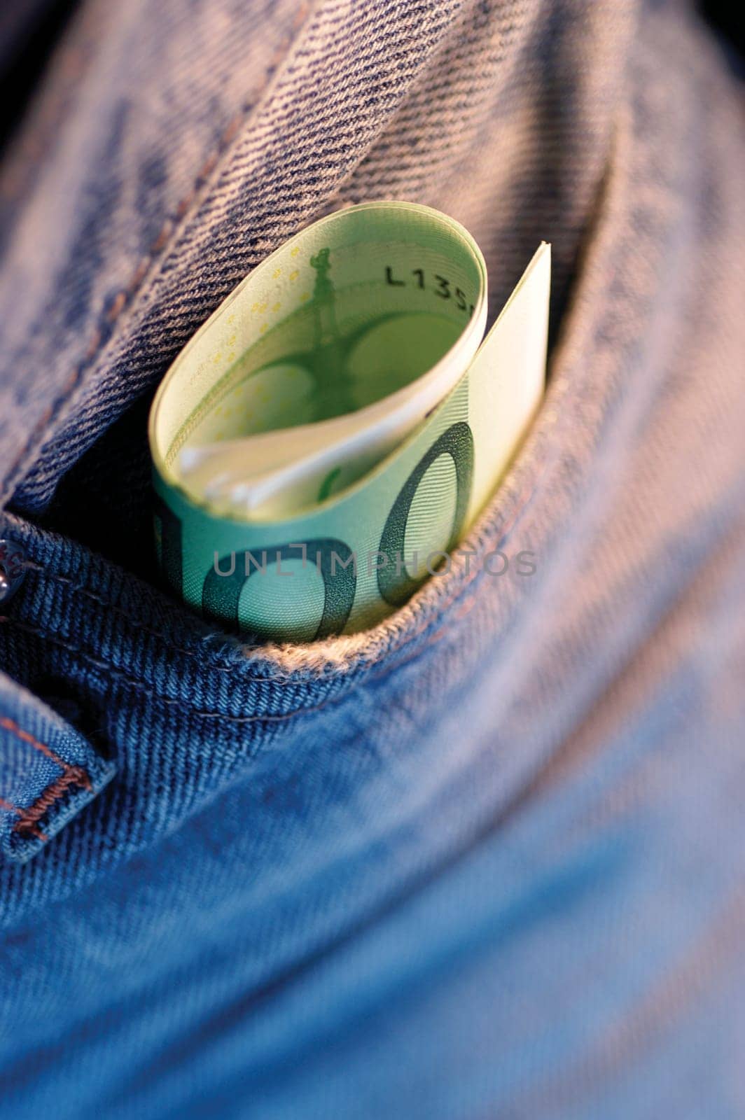 Close-up of a roll of Euro banknotes in a pocket