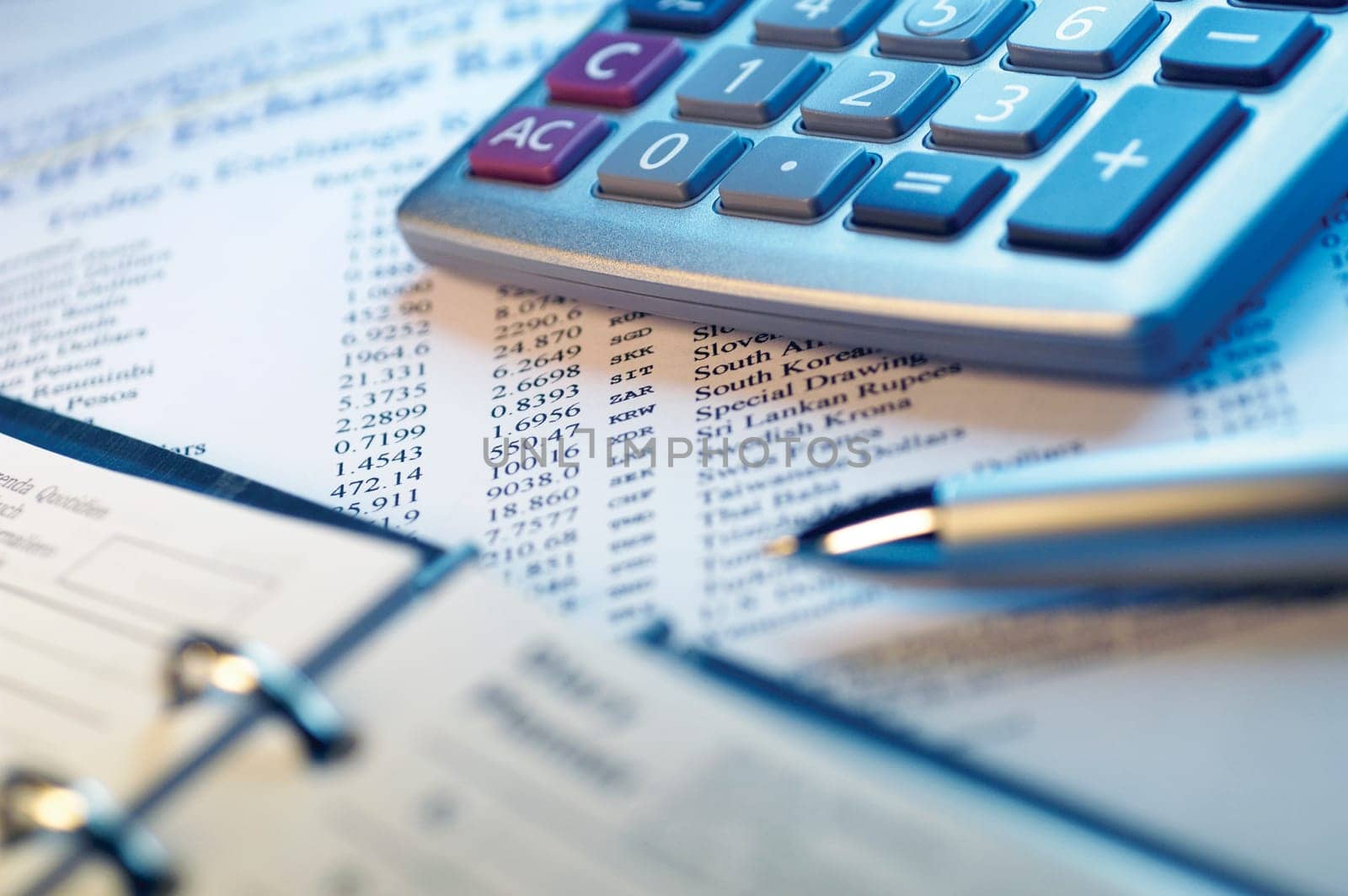 Appointment book, calculator, pen financial data, close-up