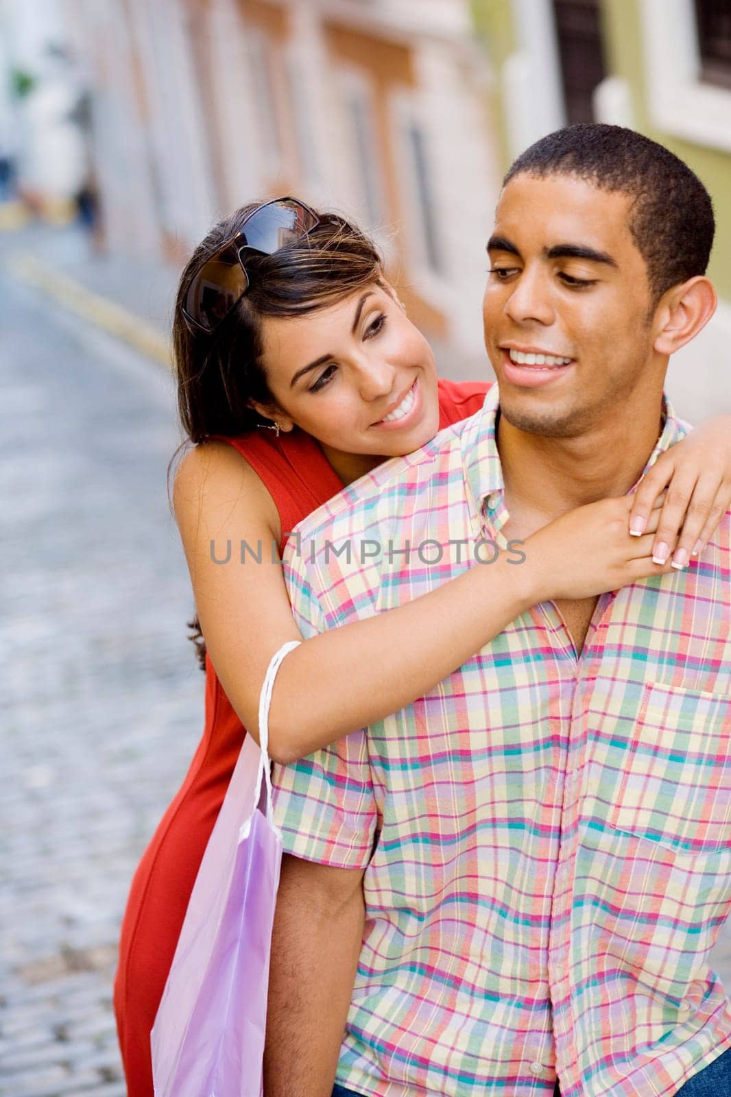 Close-up of a teenage girl embracing a young man from behind