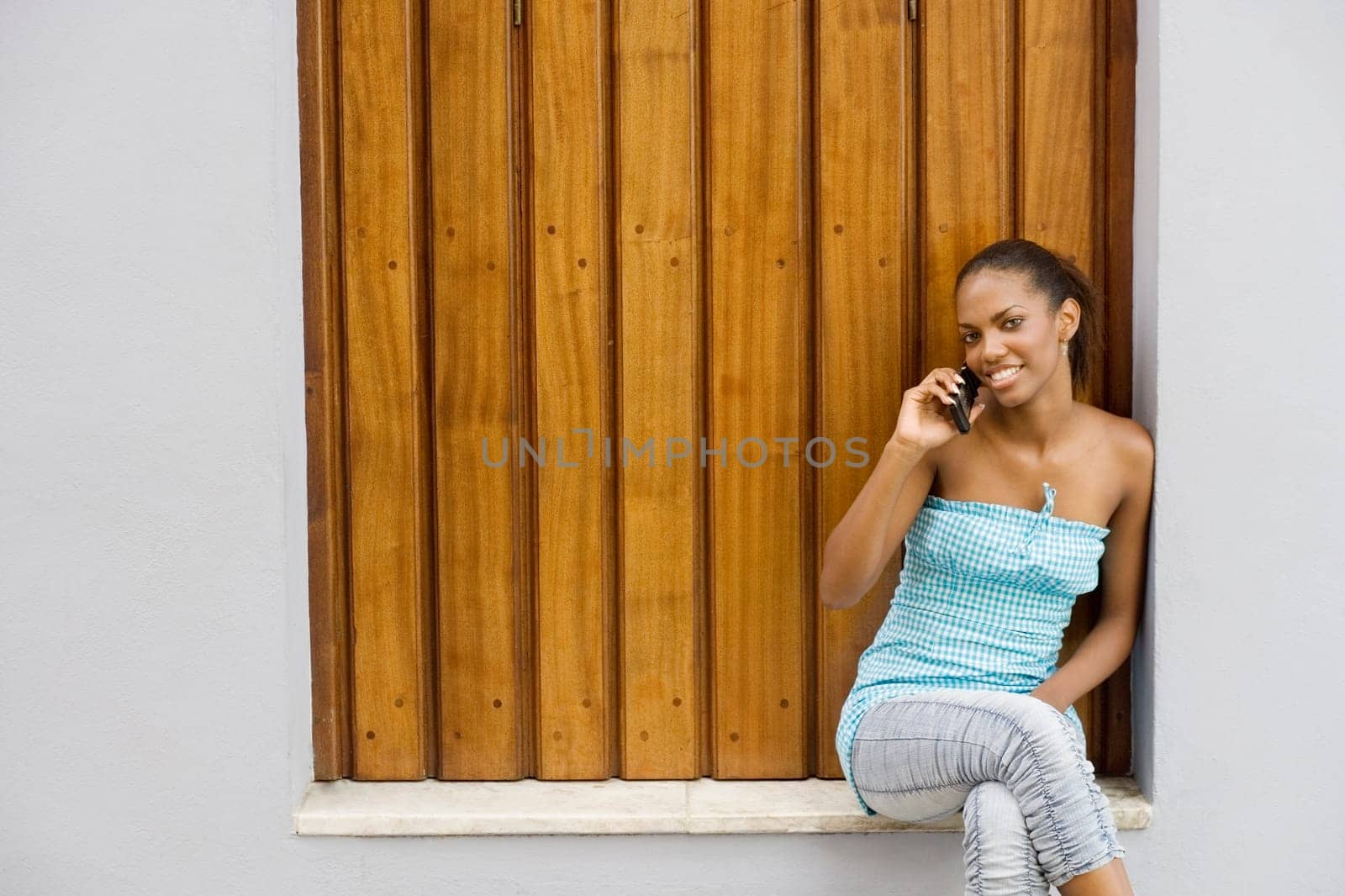 Portrait of a teenage girl smiling and talking on a mobile phone