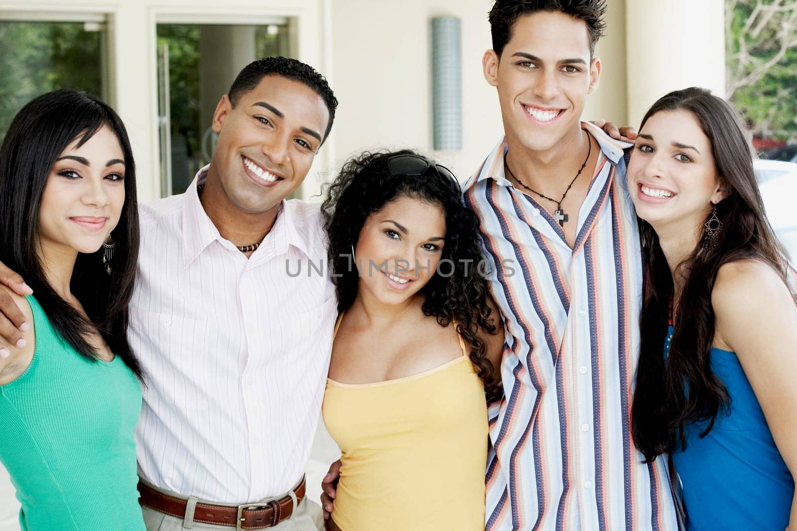 Portrait of a group of friends standing side by side and smiling