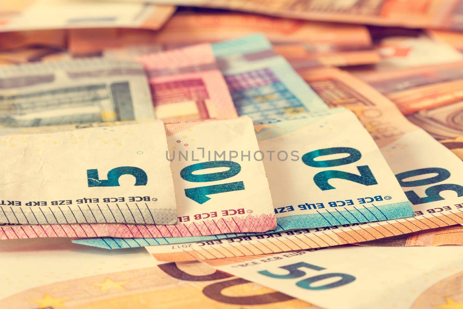 Close-up of various Euro banknotes, filtered image.