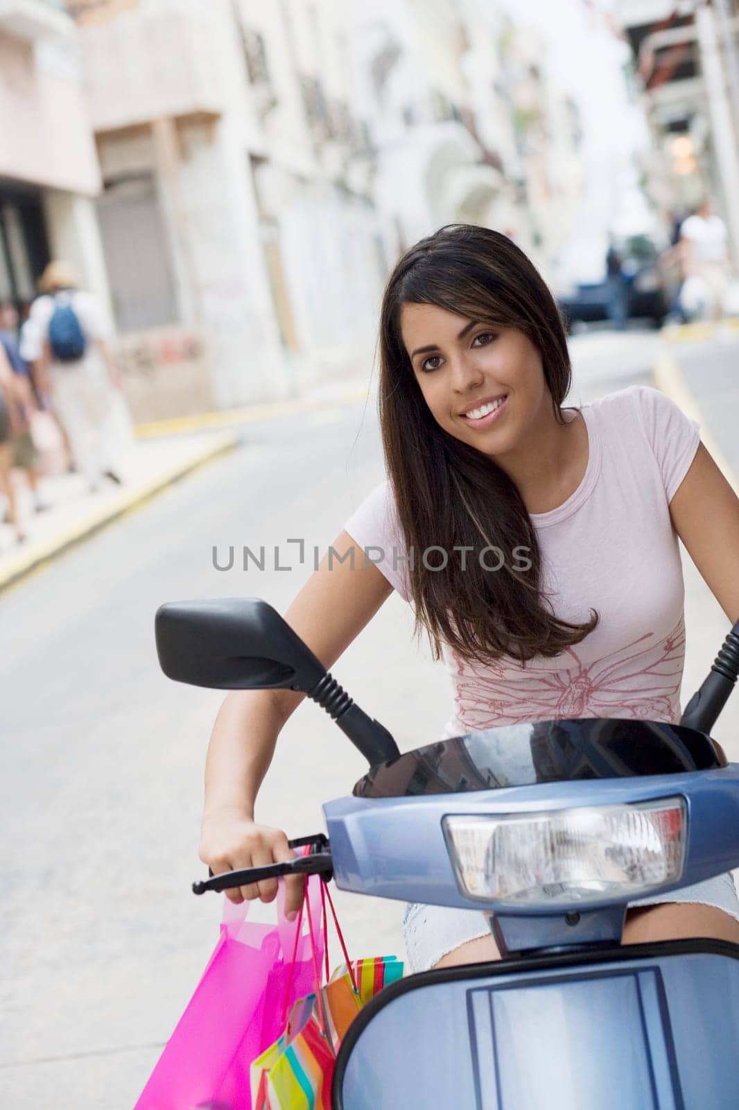 Portrait of a teenage girl riding on a motor scooter