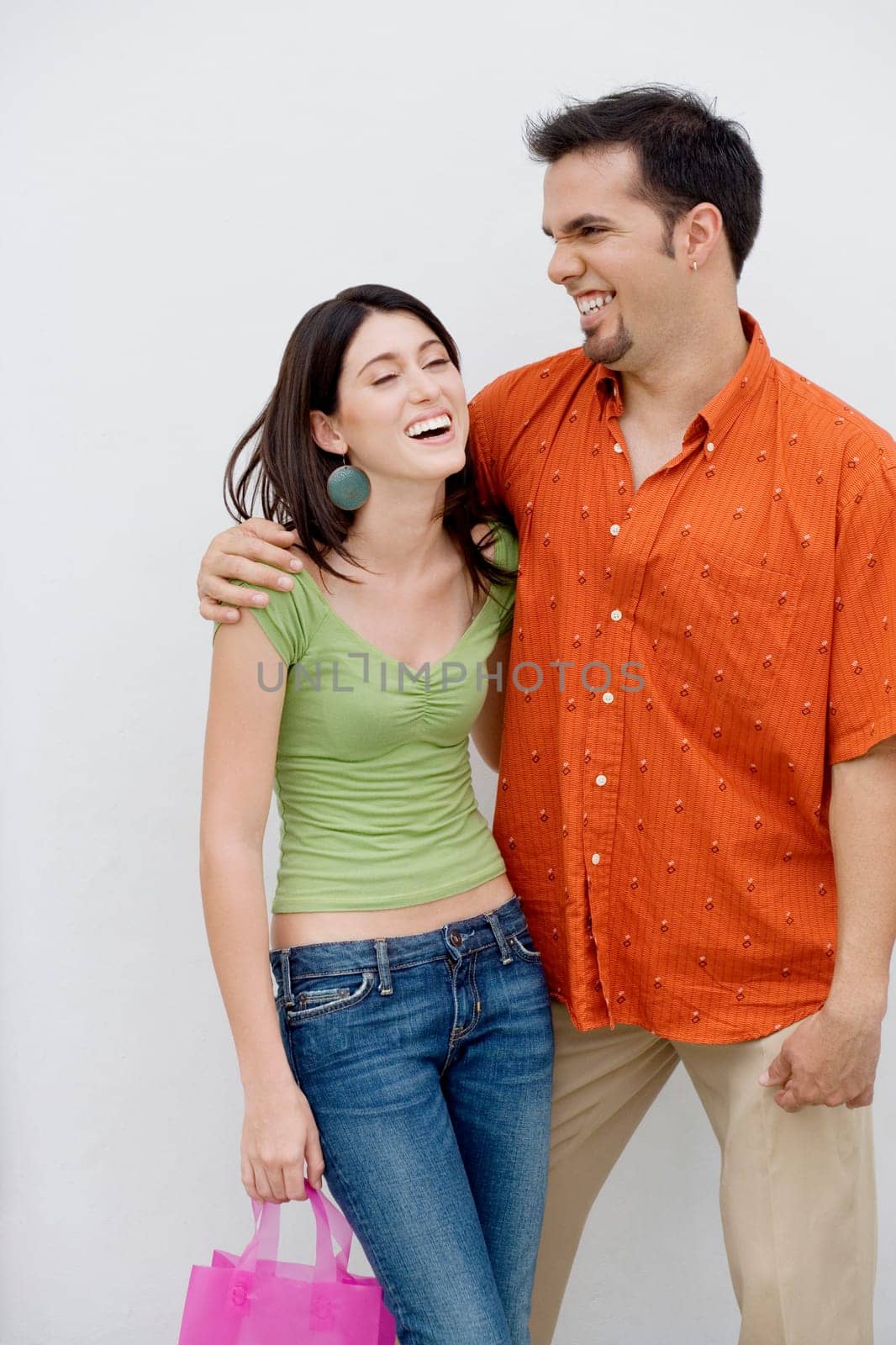Close-up of a mid adult man with his arm around a teenage girl