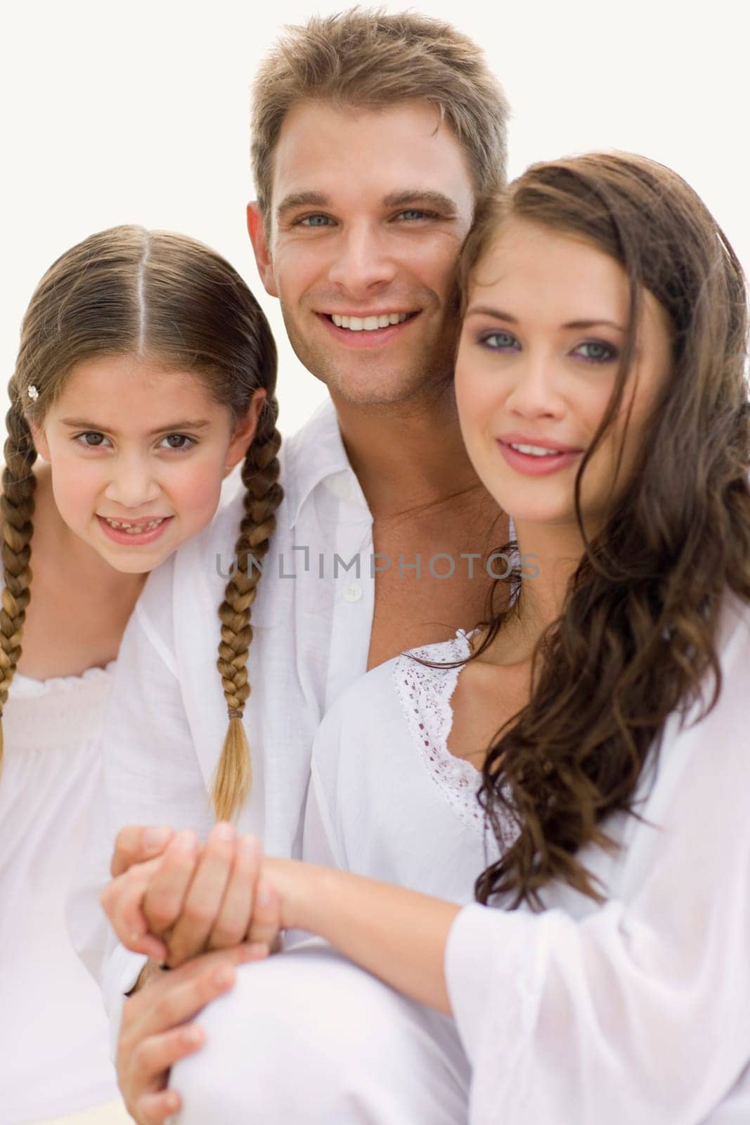 Portrait of a young couple and their daughter smiling