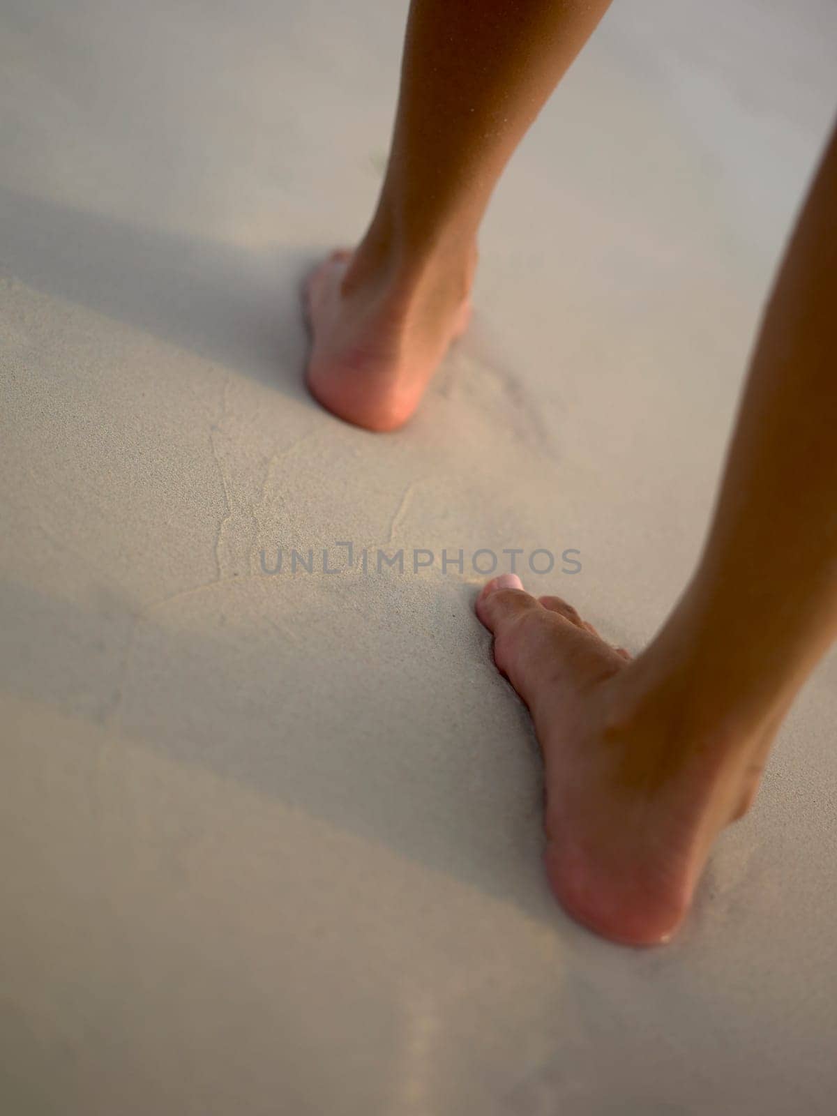 Low section view of a woman walking on the beach