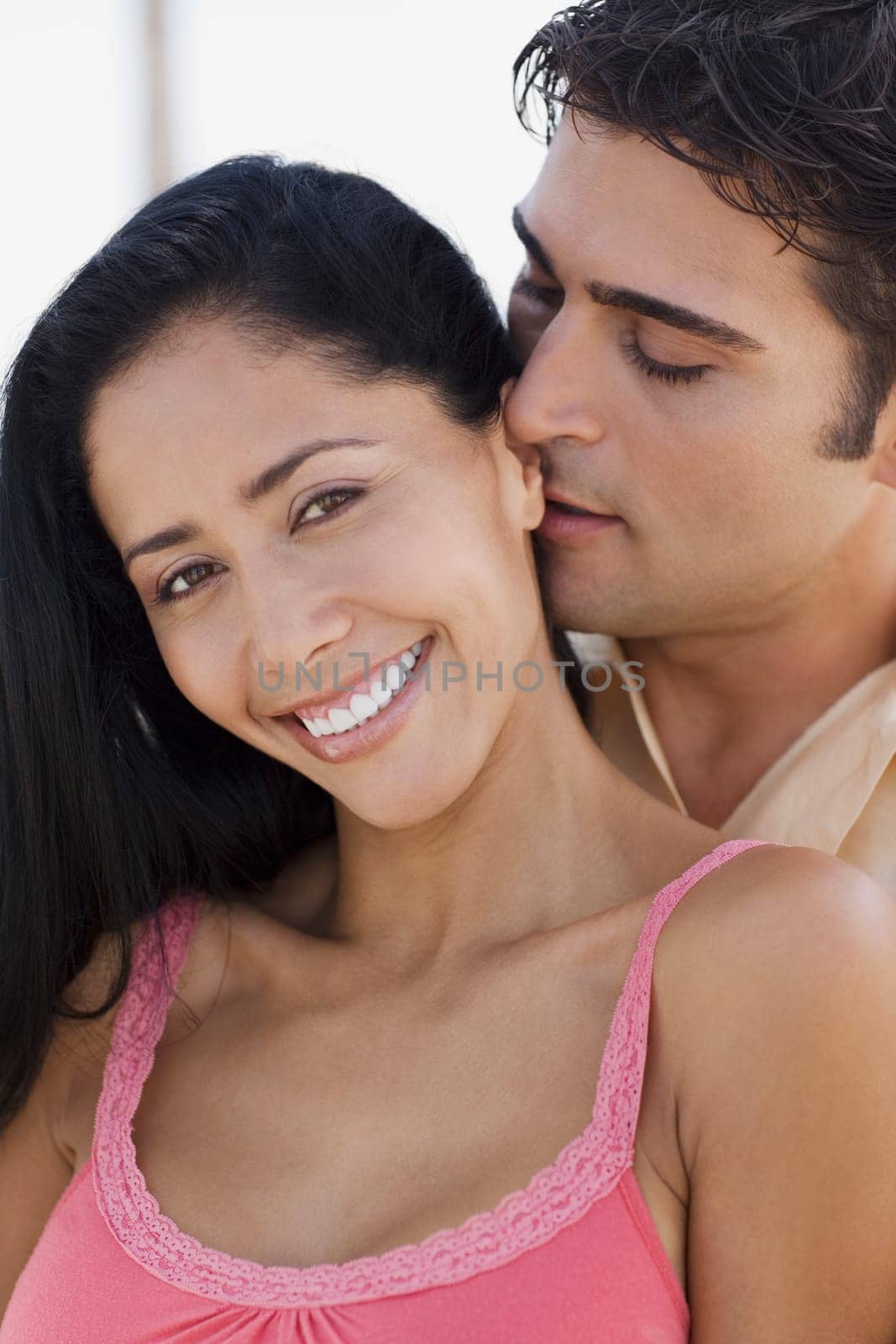 Close-up of a young man embracing a young woman from behind