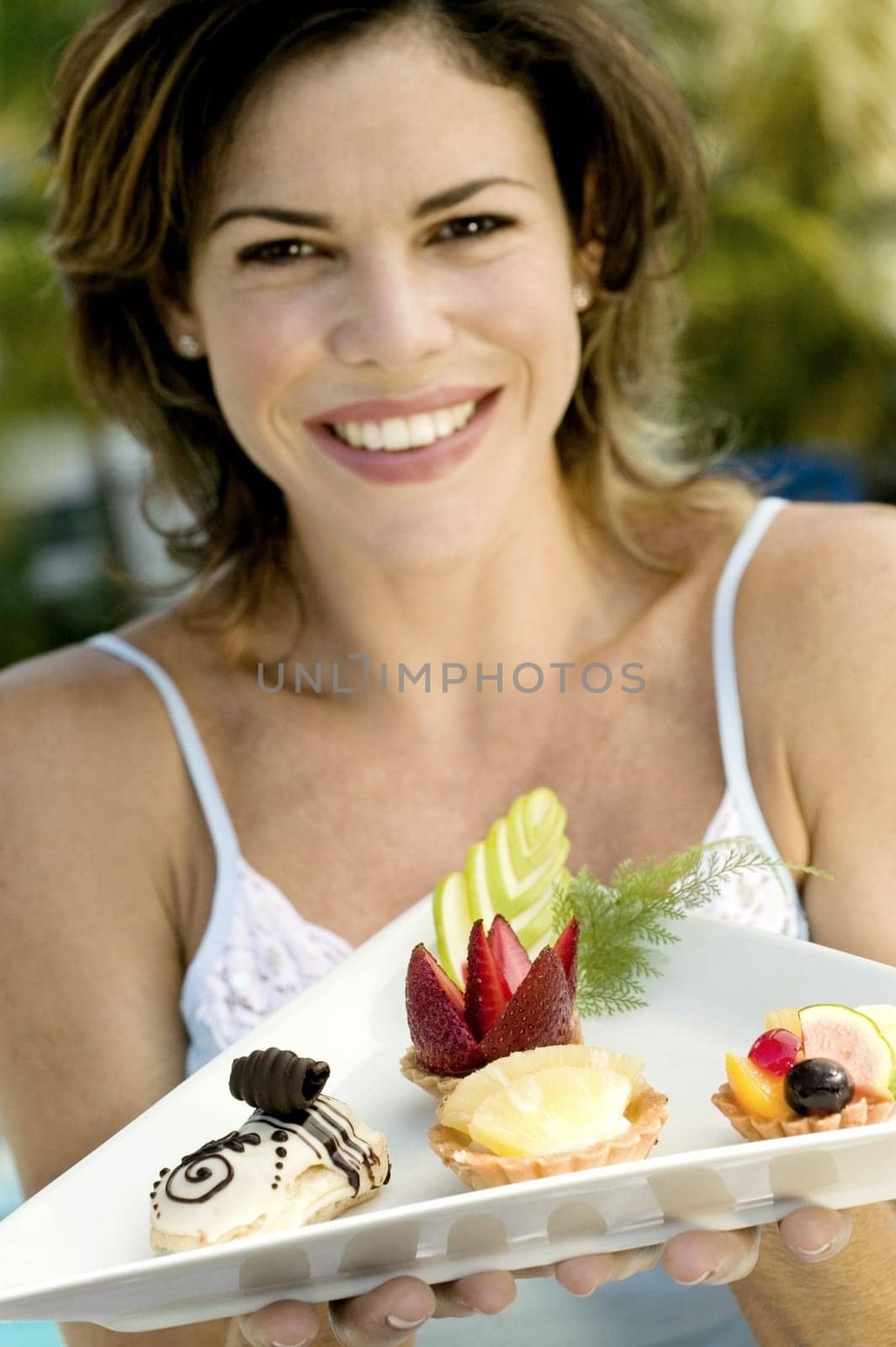 Portrait of a young woman holding a tray of food