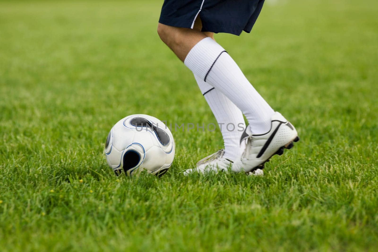 Low section view of a soccer player with a soccer ball