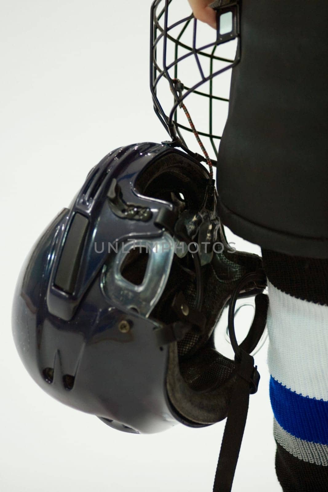 Close-up of an ice hockey player holding a helmet
