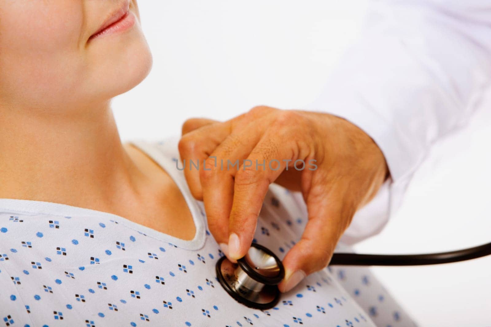 Close-up of a male doctorŽs hand examining a female patient with a stethoscope