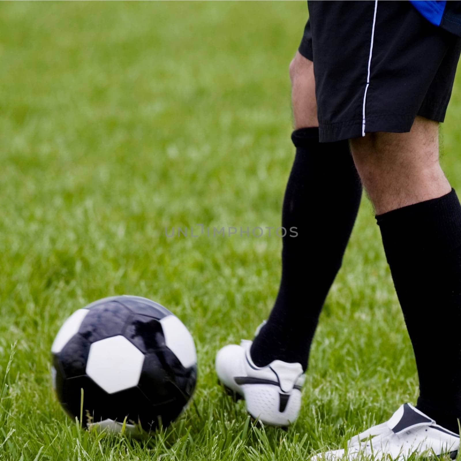 Low section view of a soccer player with a soccer ball