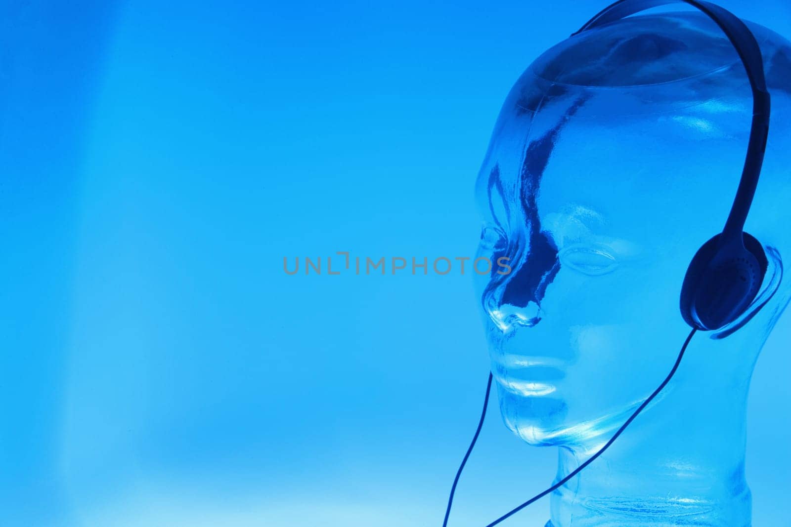 Close-up of a glass mannequin wearing headphones