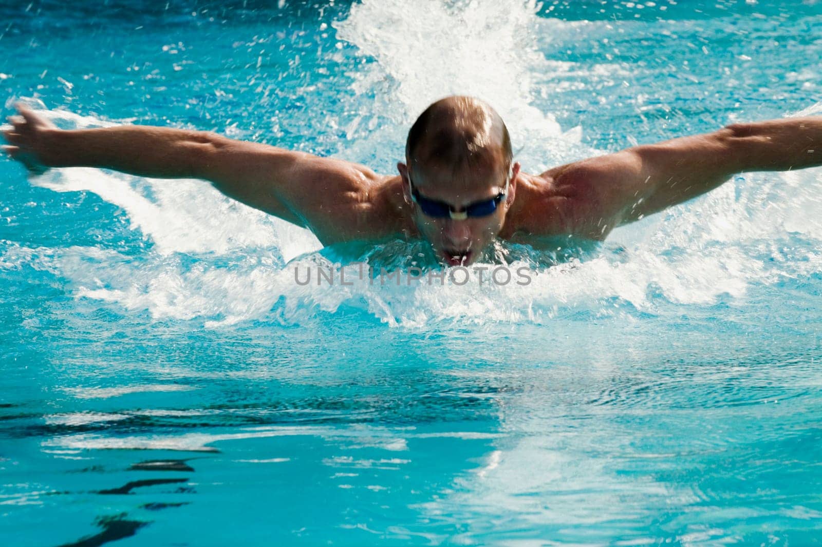 Mid adult man swimming in a swimming pool