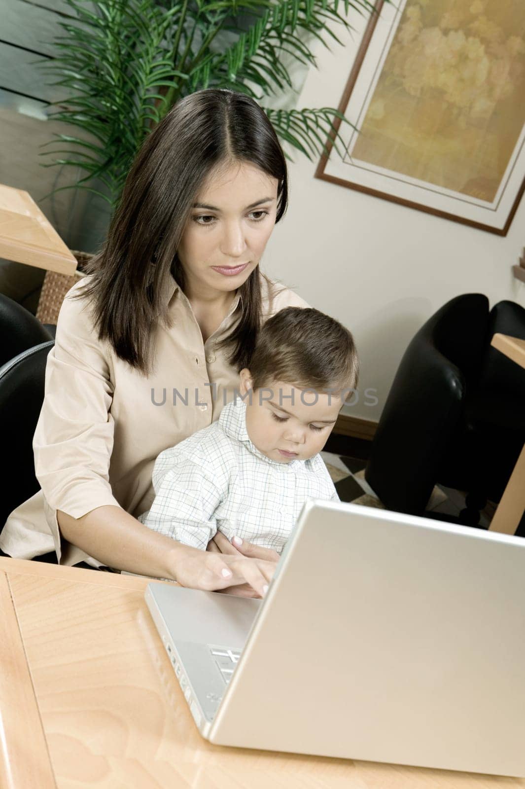High angle view of a mother using a laptop with her son