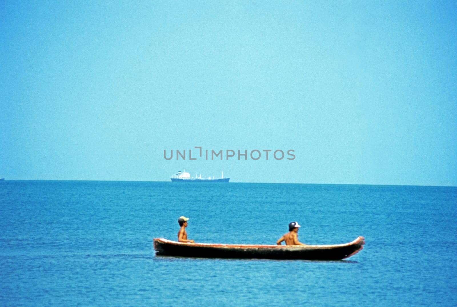 Two young men kayaking in the sea