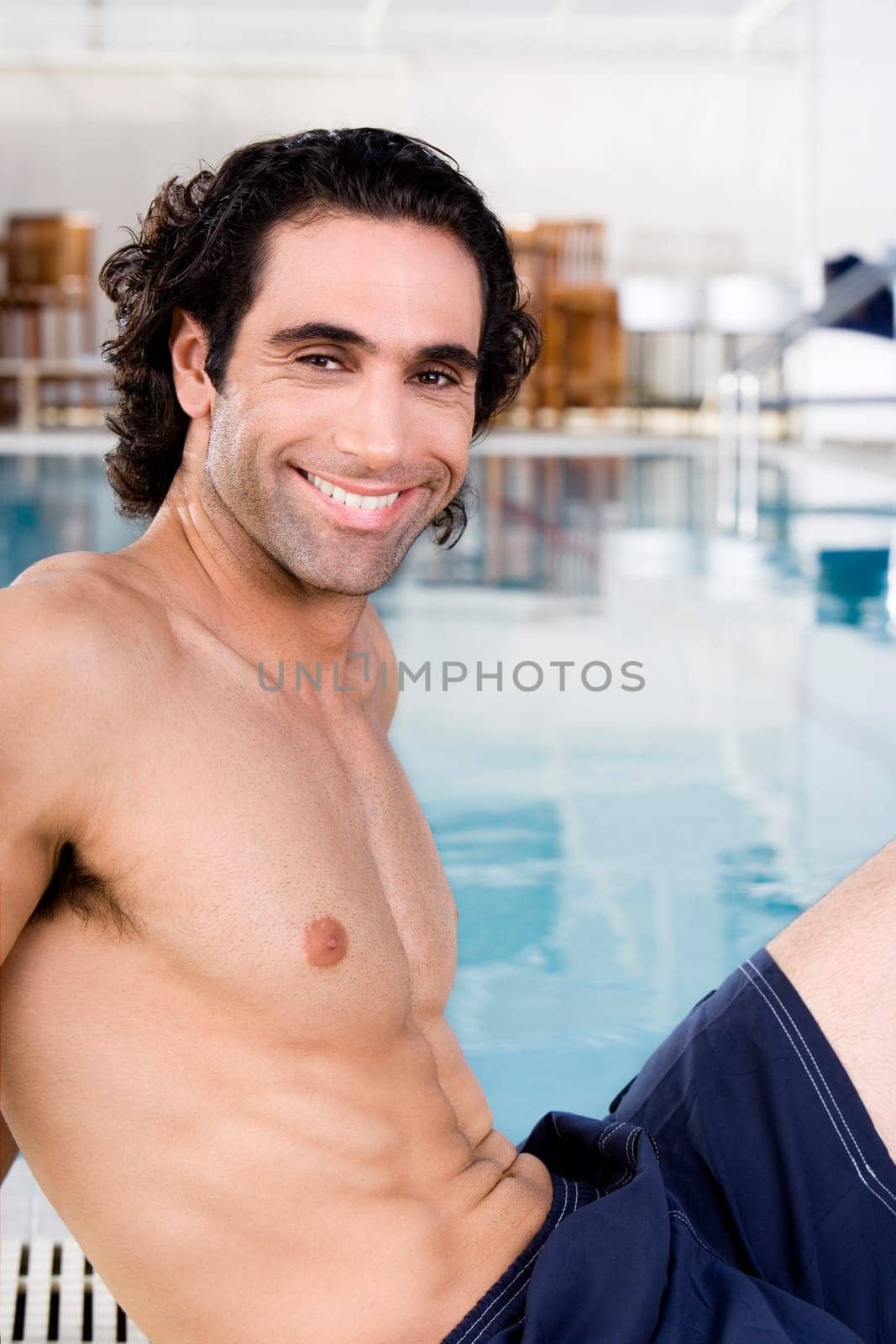 Portrait of a mid adult man sitting at the poolside