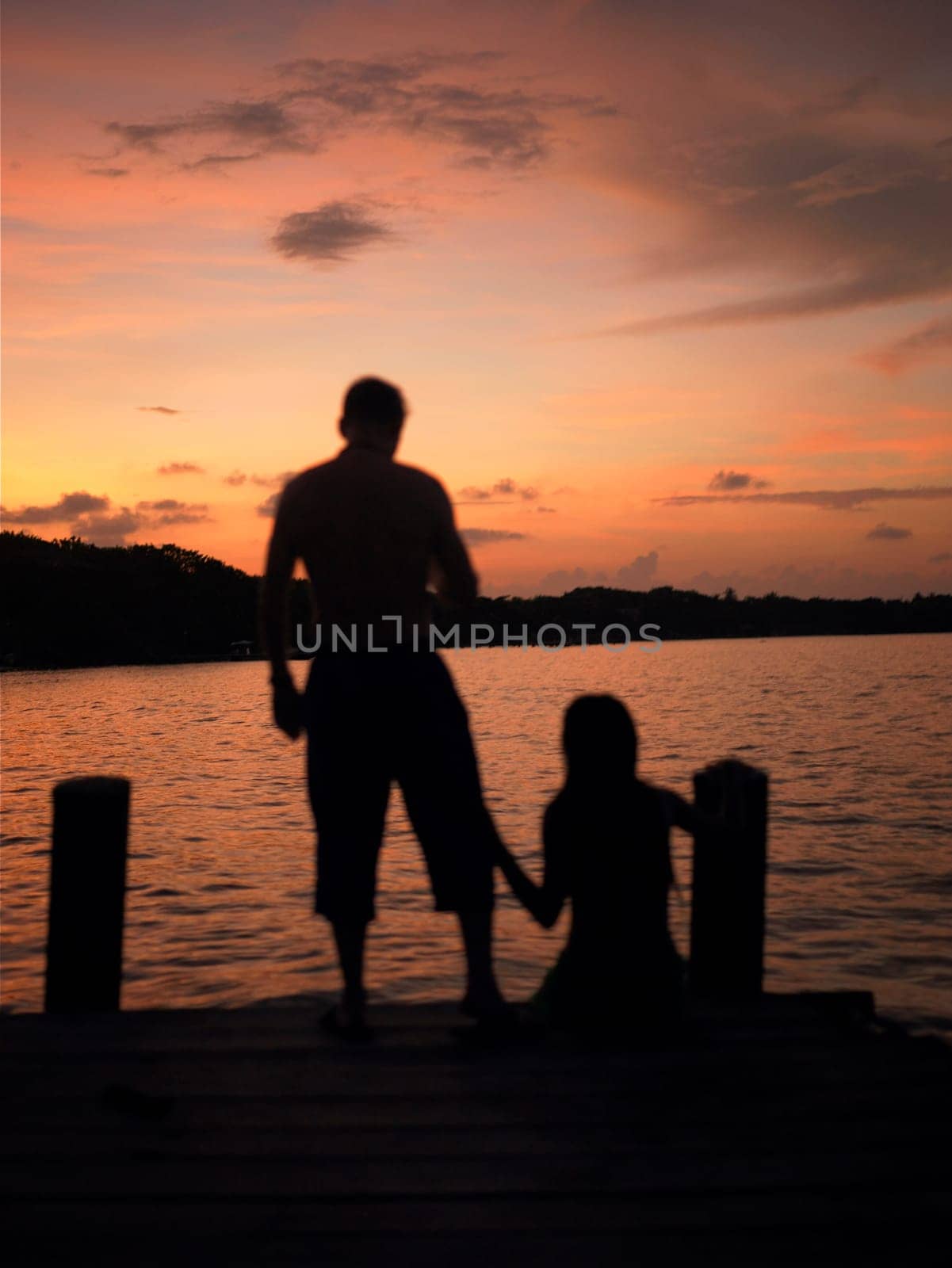 Silhouette of a man and a woman on a pier