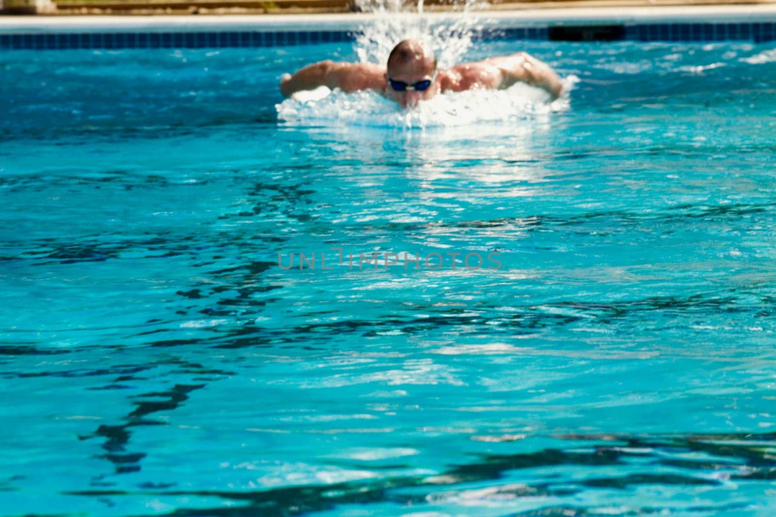 Mid adult man swimming in a swimming pool