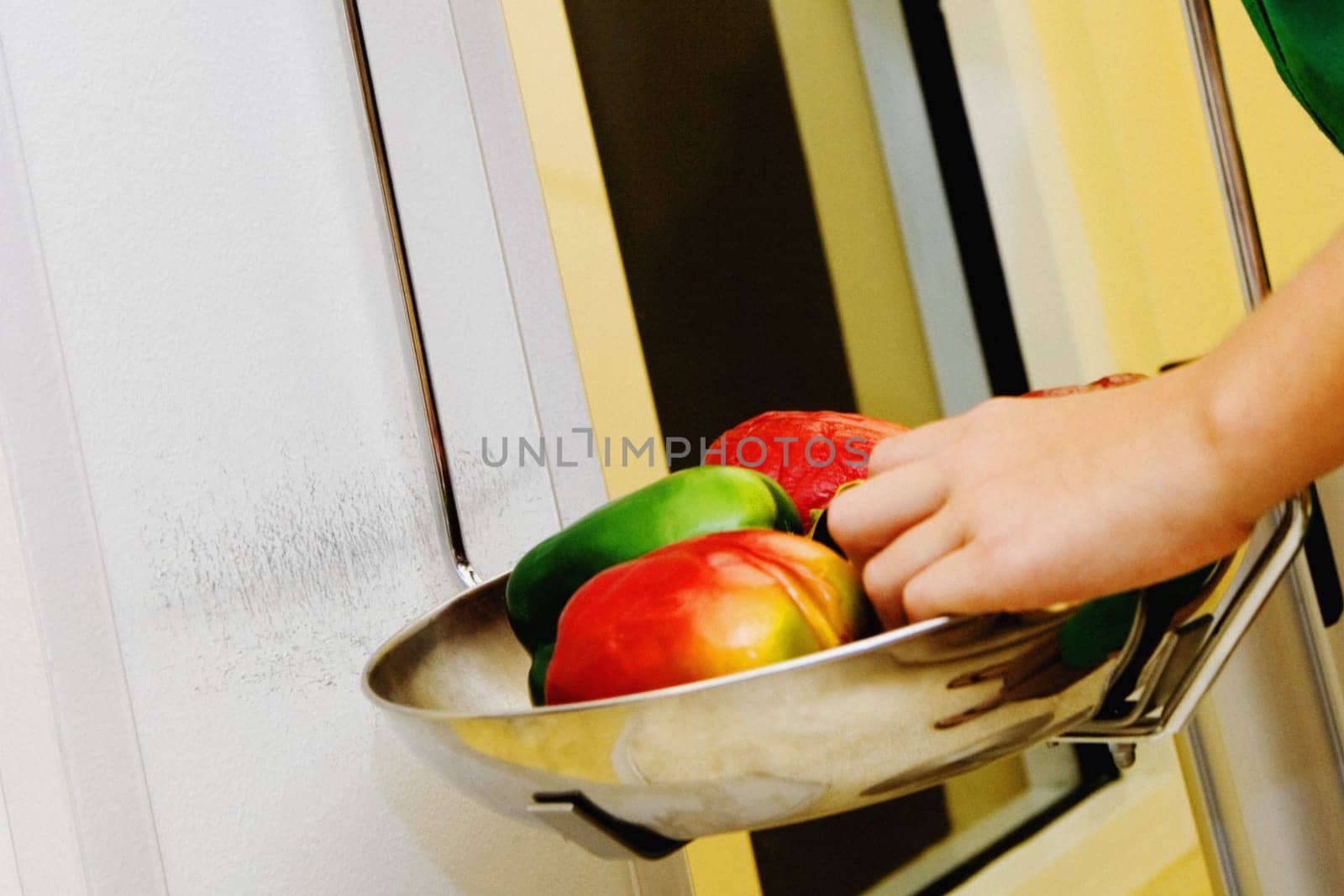 Close-up of a girl weighing vegetables in a weight scale