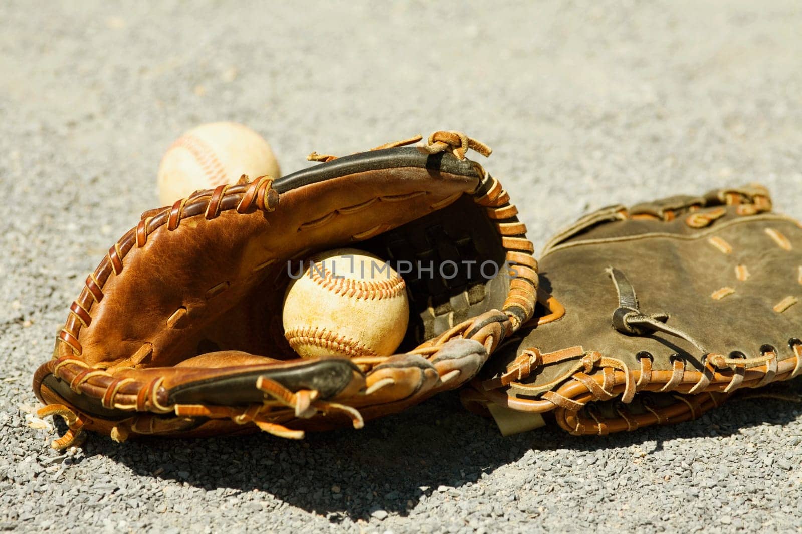 Close-up of two baseball gloves and two baseballs