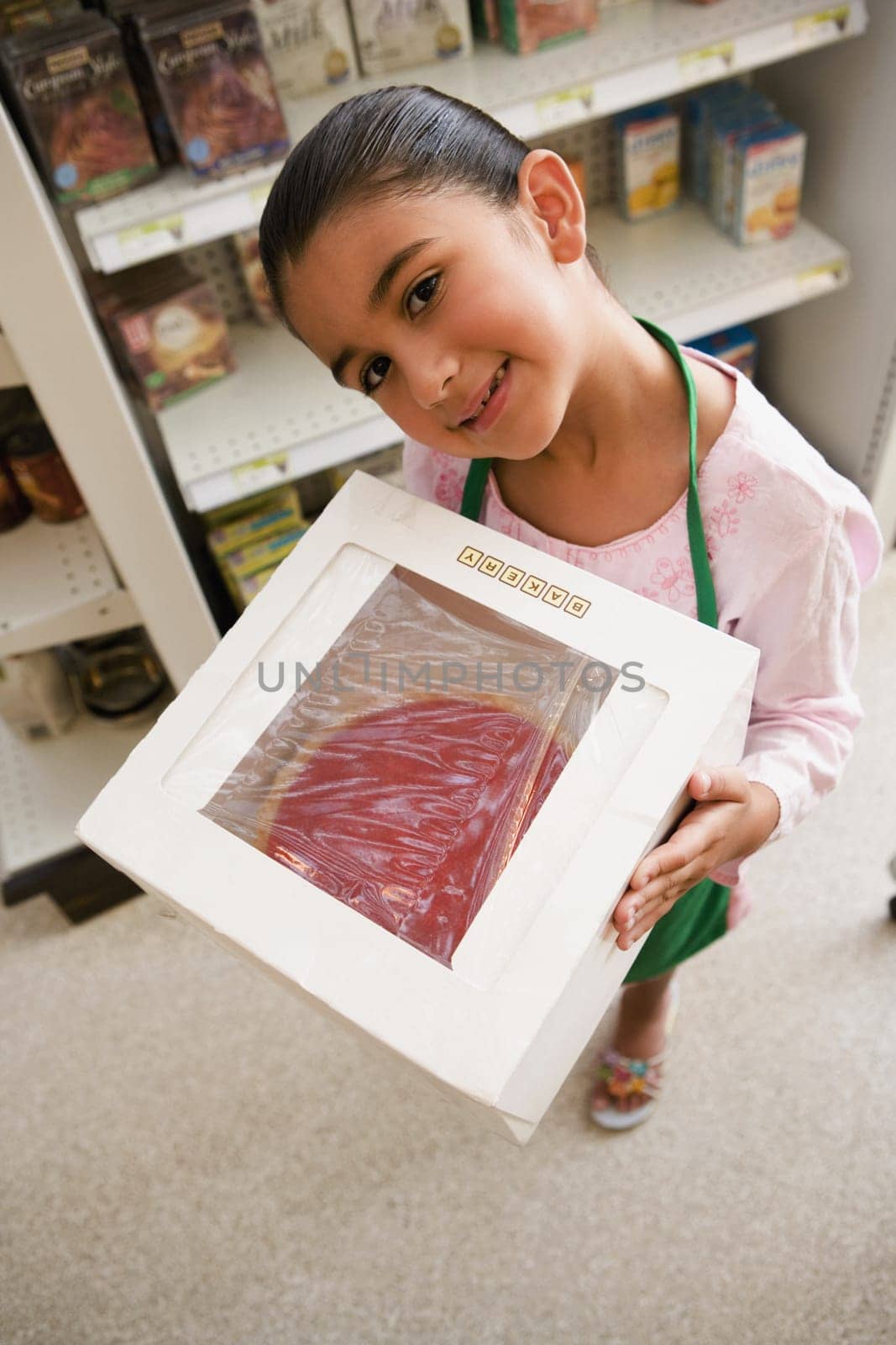 Portrait of a girl holding a box of cake