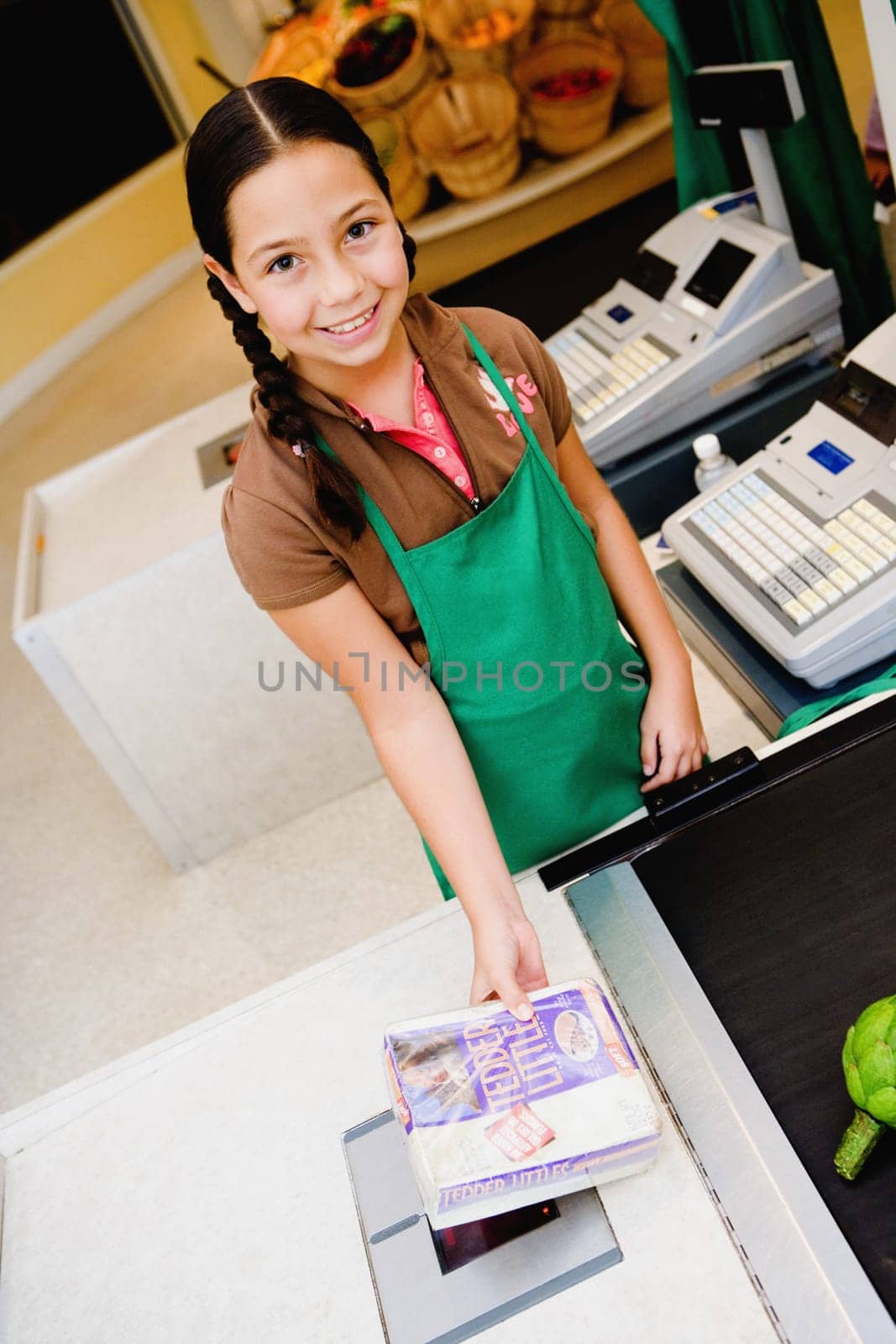 Portrait of a girl holding a box at the checkout counter of a store