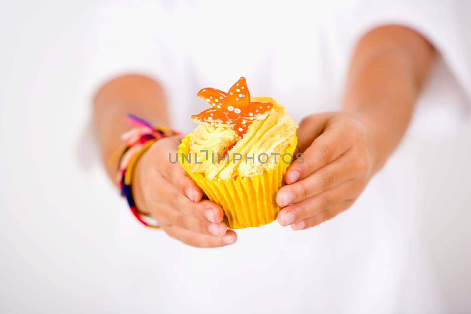 Close-up of a childŽs hand holding a cupcake