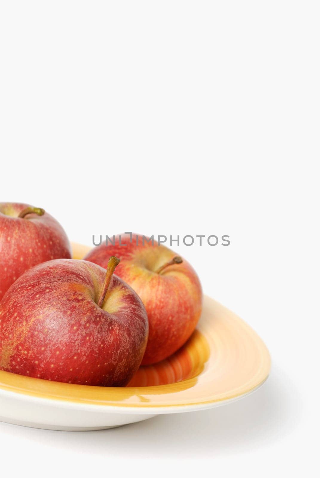 Close-up of three apples on a tray